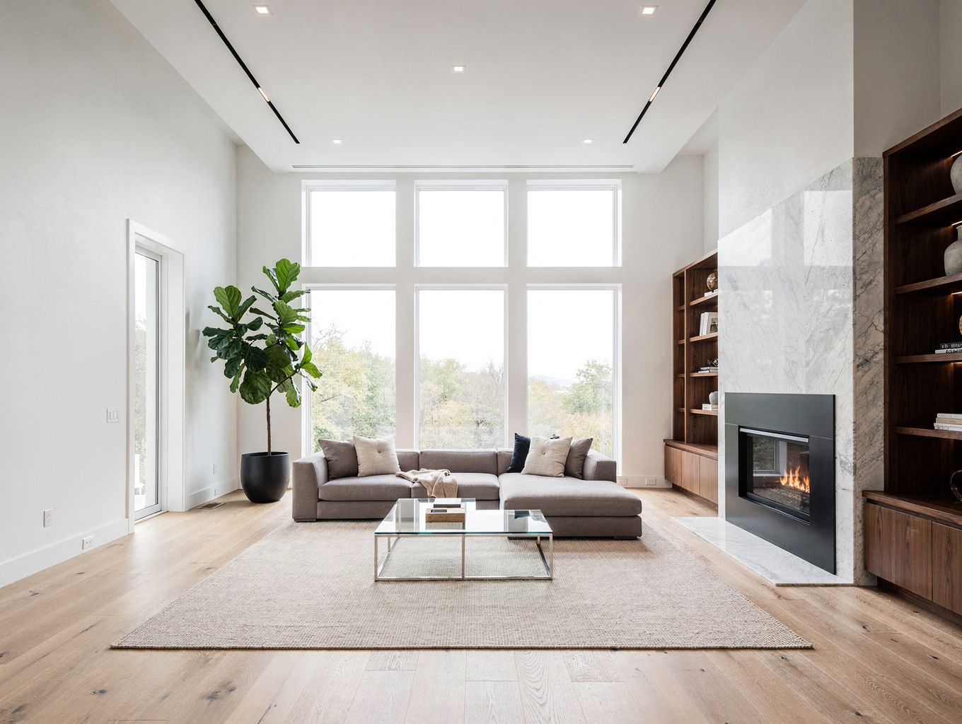 Remodeled open-concept main floor living space with seamless European oak hardwood floors, architectural cased openings, and fireplace built-in cabinetry