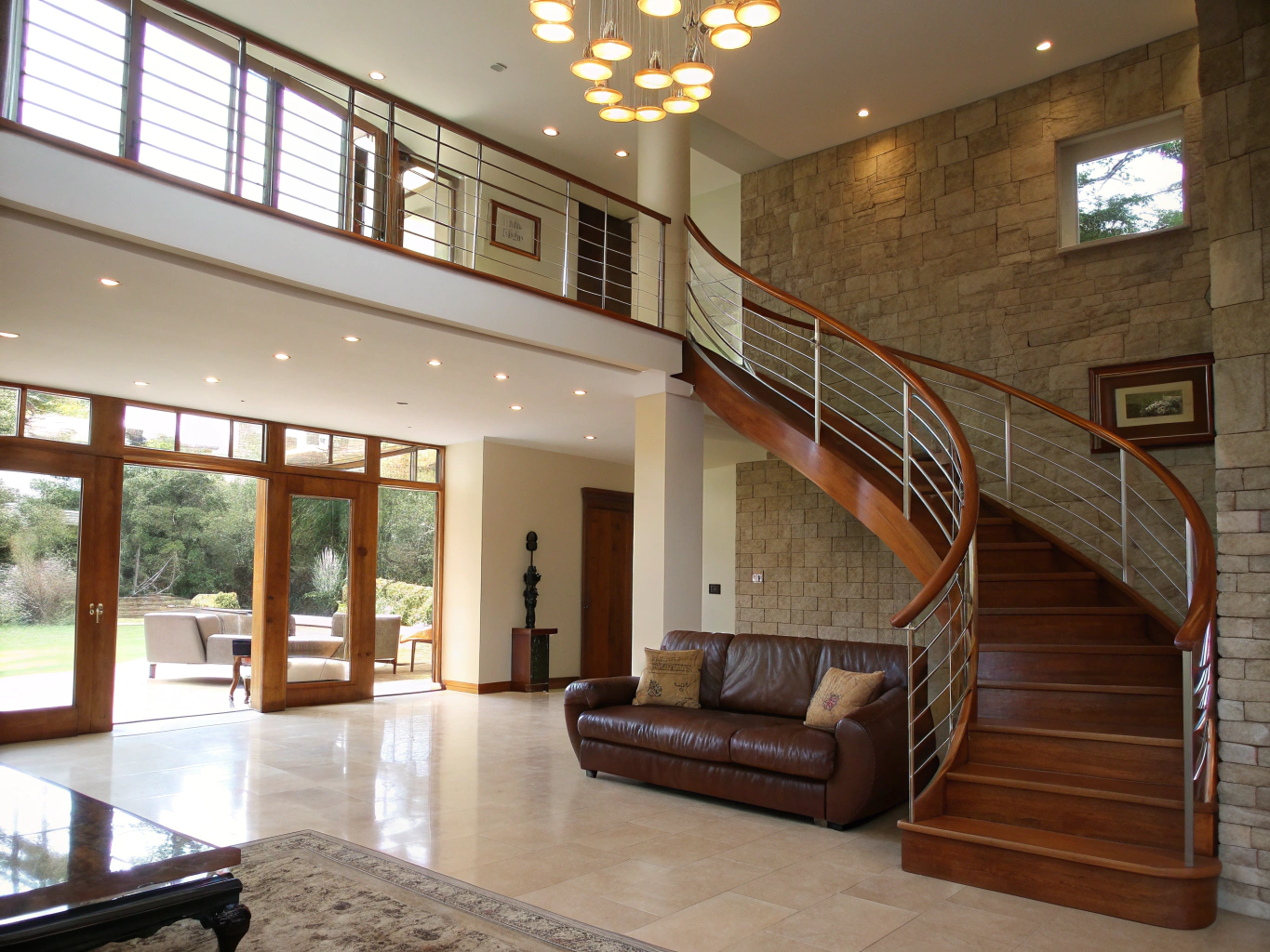 Whole-home interior remodel in Forest Hills Smyrna showing open staircase, custom plaster fireplace surround, and warm oak floors